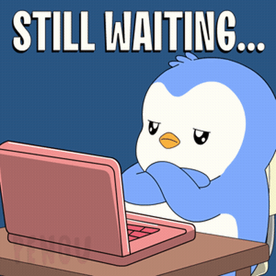 Penguin At Desk With Laptop Still Waiting GIF