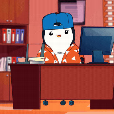 Penguin In Blue Hat At Desk With Computer GIF