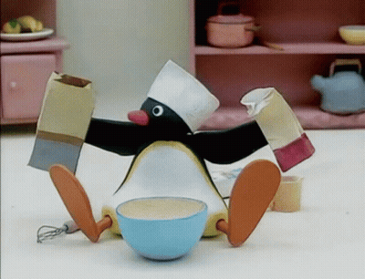 Penguin In Chef Hat Sitting Next To Bowl Of Food GIF