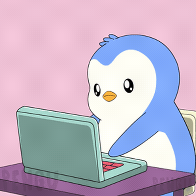 Penguin Sitting at Desk With Laptop