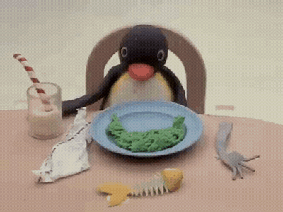 Penguin Sitting At Table With Food And Milk GIF