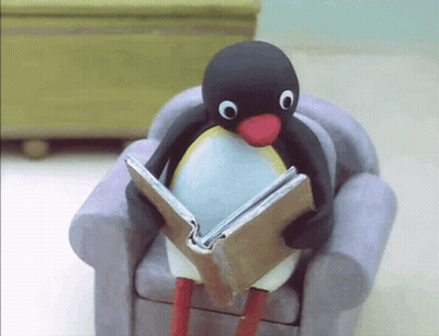 Penguin Sitting On Chair Reading Book GIF