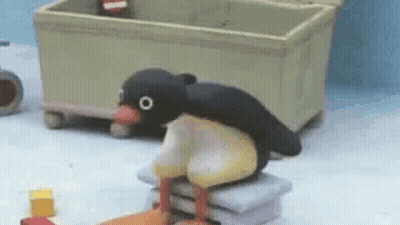 Penguin Sitting On Pillows GIF
