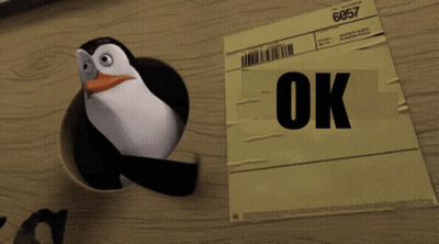 Penguin Standing Next To OK Paper GIF