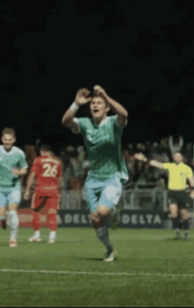 Penguin Wearing Ear Muffs Next To Soccer Ball On Flag GIF