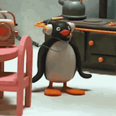 Penguin Wearing Headphones In Front Of Radio GIF