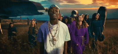 People And Man With Necklace In Field GIF
