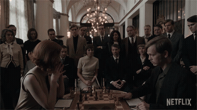 People Around Chess Board With Netflix Logo GIF