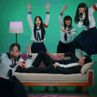People Around Man On Couch With Arms Up GIF