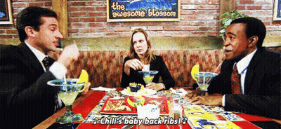 People At Table With The Awesome Blossom Sign GIF
