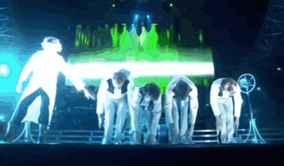 People Bending Over On Green Stage GIF