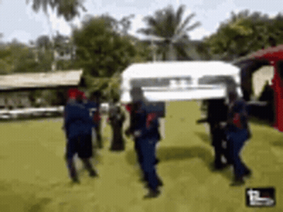 People Carrying White Coffin On Stretcher GIF