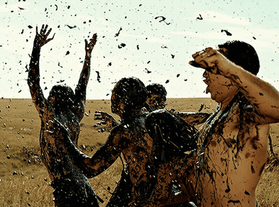 People Covered In Mud With Flying Birds GIF