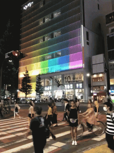 People Crossing Street Near Building 10 GIF