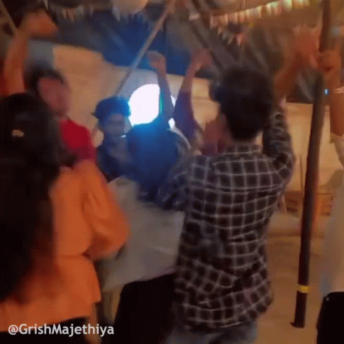 People Dancing Around Table GIF