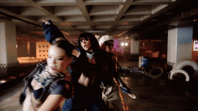 People Dancing In Dark Room With Pink Sign GIF