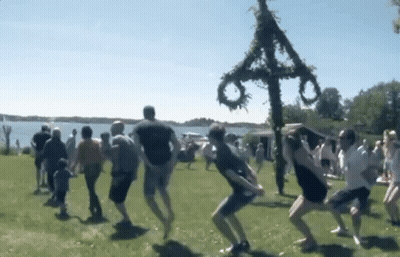 People Dancing In Field Front Of Cross GIF