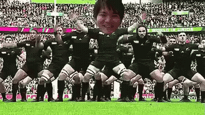 People Dancing In Field In Front Of World Cup Sign GIF