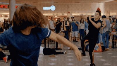 People Dancing In Front Of Bakery GIF