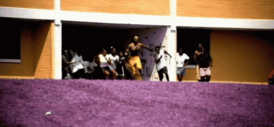 People Dancing In Front Of Graffiti Building GIF