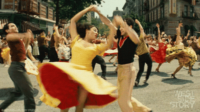People Dancing In Front Of Hotel Sign GIF