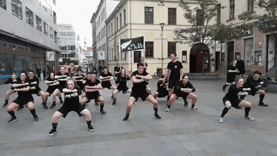 People Dancing In Front Of Sign All In Black GIF
