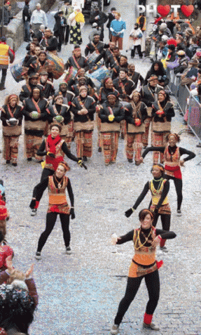 People Dancing In Parade With DH Sign GIF