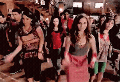 People Dancing in Room Woman in Red Dress