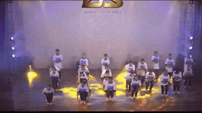 People Dancing On Stage With Dance Company Logo GIF