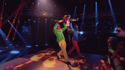 People Dancing On Stage With Green Jacket GIF