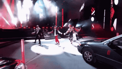 People Dancing On Stage With Parked Car GIF