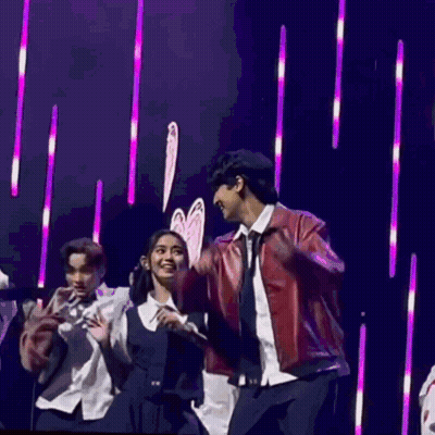 People Dancing On Stage With Purple Lights GIF