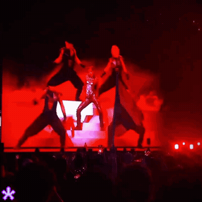 People Dancing On Stage With Red Lights GIF