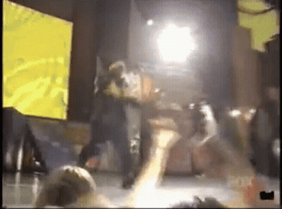 People Dancing On Stage With Yellow Screen GIF