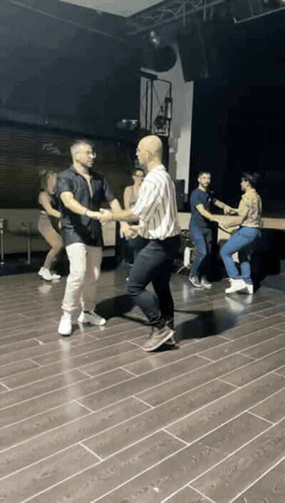 People Dancing On Wooden Floor In Dark Room GIF