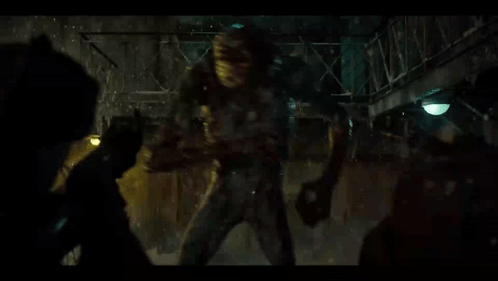 People Fighting Monster In Dark Room GIF