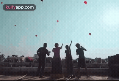 People Flying Kites On Building GIF