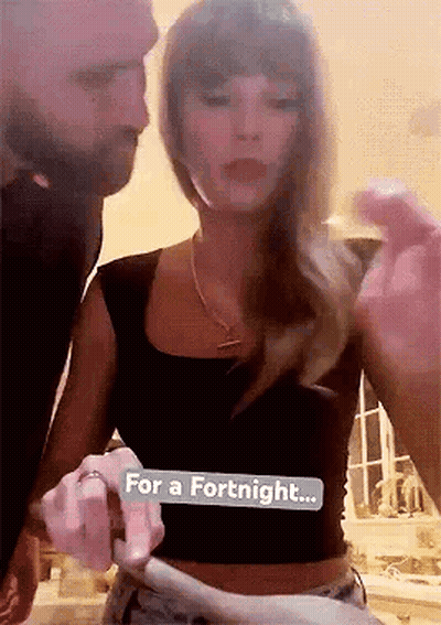 People Gathered Around Kissing Couple GIF