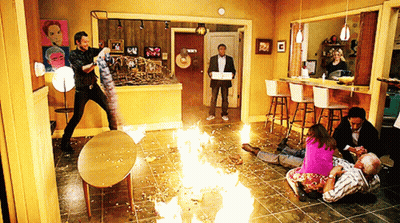 People Gathered In Living Room With Fire GIF