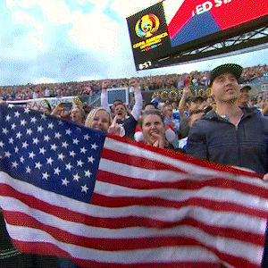 People Holding American Flag with Scoreboard Saying Ed