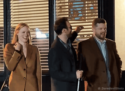 People In Front Of Window With Blinds GIF