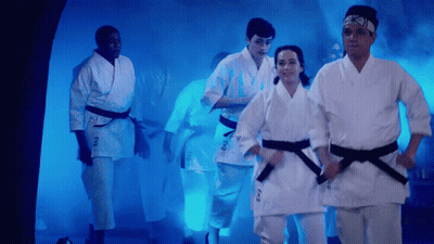 People In Karate Uniforms Walking Through Tunnel GIF