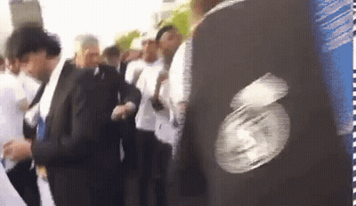 People In Line, Person In Black Jacket With Face GIF