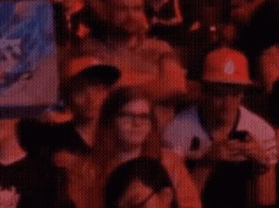 People In Stadium Watching Game On Phones GIF