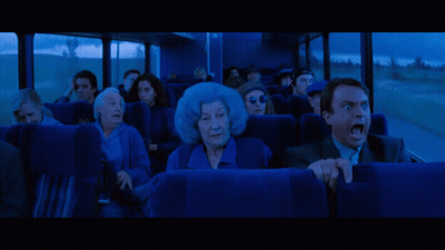People Looking At Large Red Monster In Dark GIF