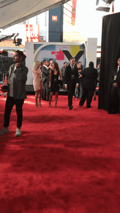 People On Red Carpet In Front Of JBL Sign GIF