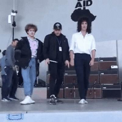 People On Stage Saying Aid GIF