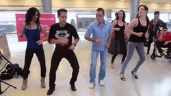 People Performing Salsa At Airport GIF