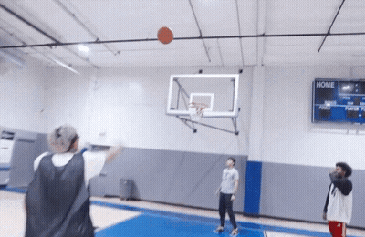 People Playing Basketball In A Gym With A Scoreboard That Says Home On It GIF