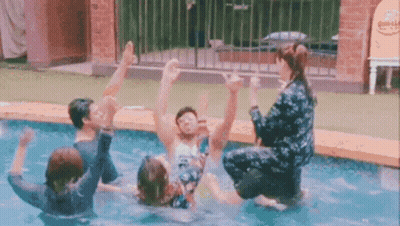 People Playing In Pool Woman Sitting On Man's Shoulders GIF